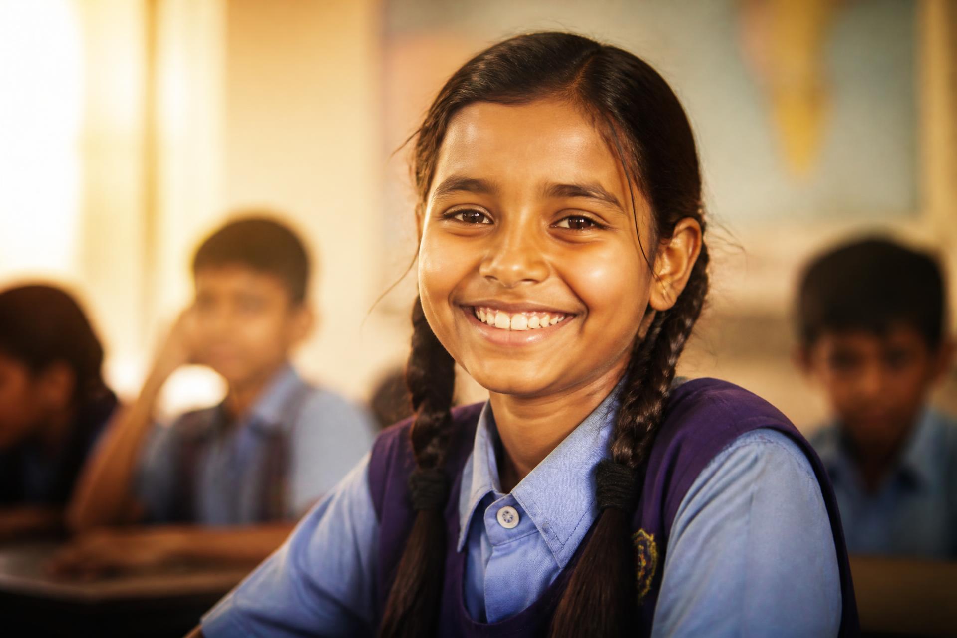 Smiling Indian school girl in her classroom